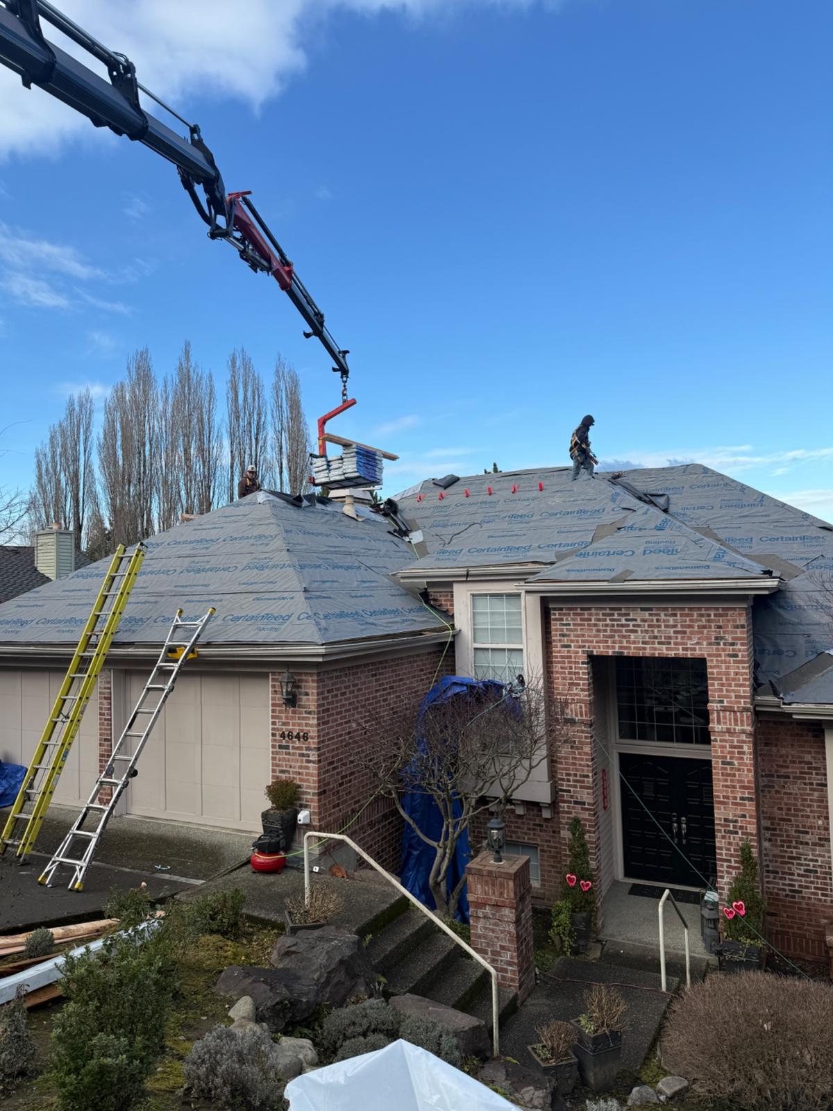 Crane delivering materials to roof